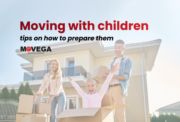 happy family playing with boxes in front of a house