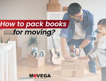 A man packs books into a box