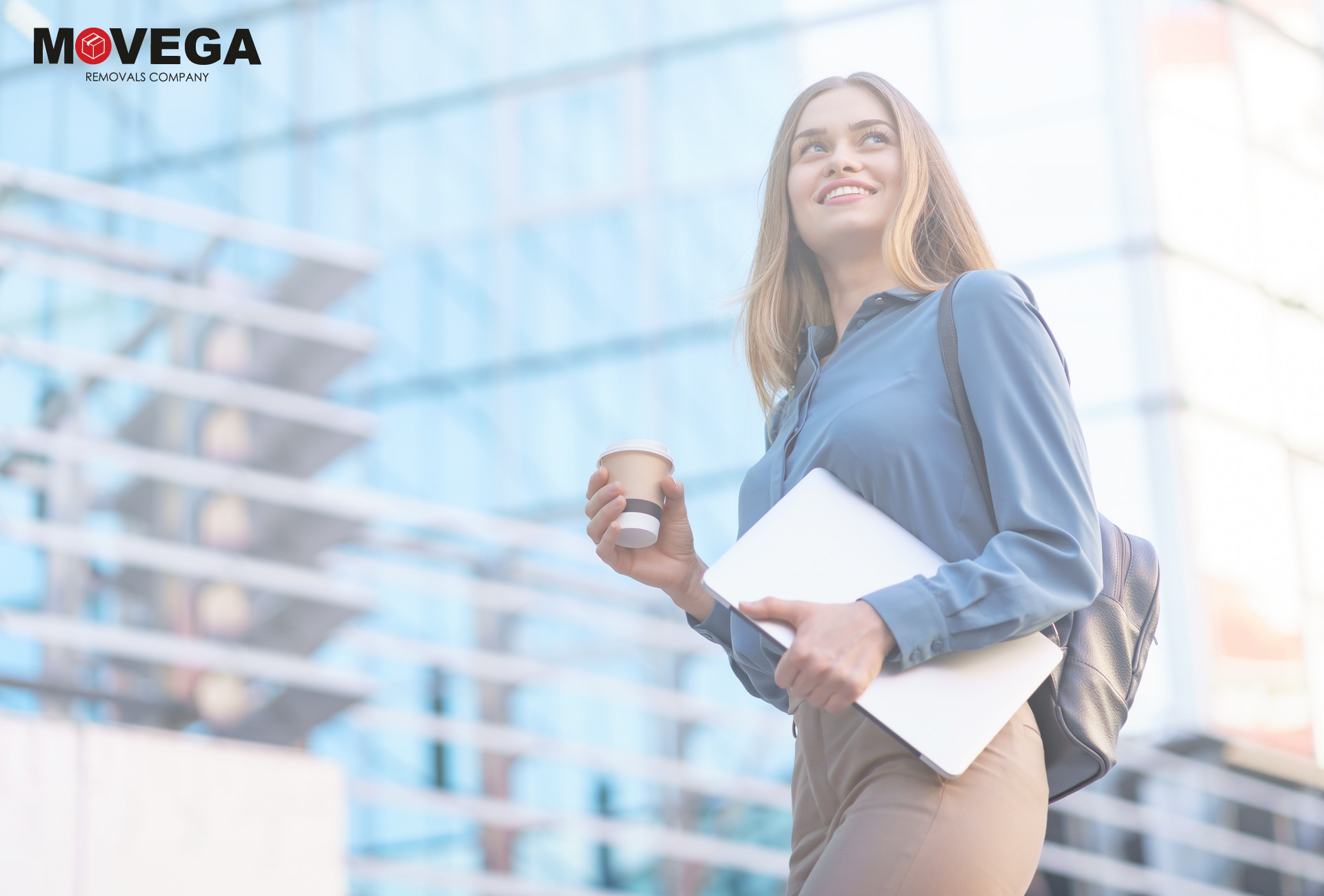 a european blonde woman with a blue shirt ot a corporate background