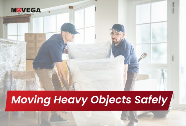 Two men moving heavy furniture