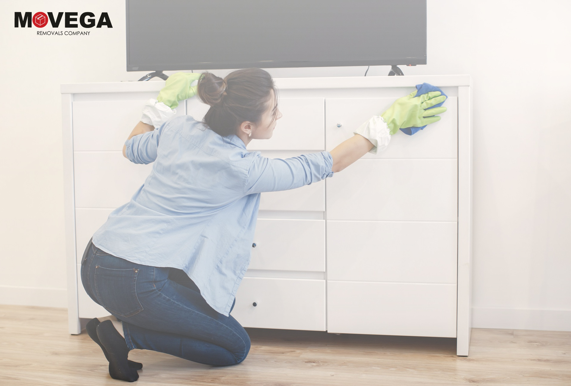 A woman cleaning white furniture